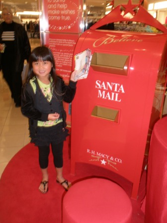 Kasen mailing Santa letters from her class